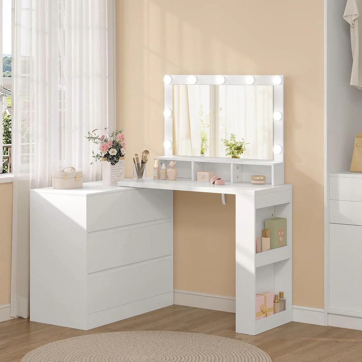 White corner dressing table in a bedroom: 6-drawer chest, bulb mirror, side shelf unit