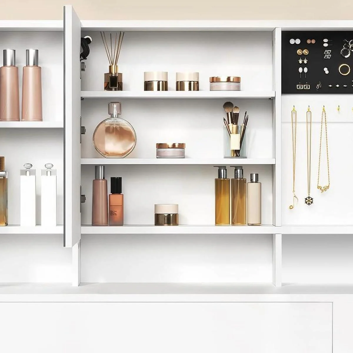 The mirror panels open on the cabinets: bottles, earrings and necklaces