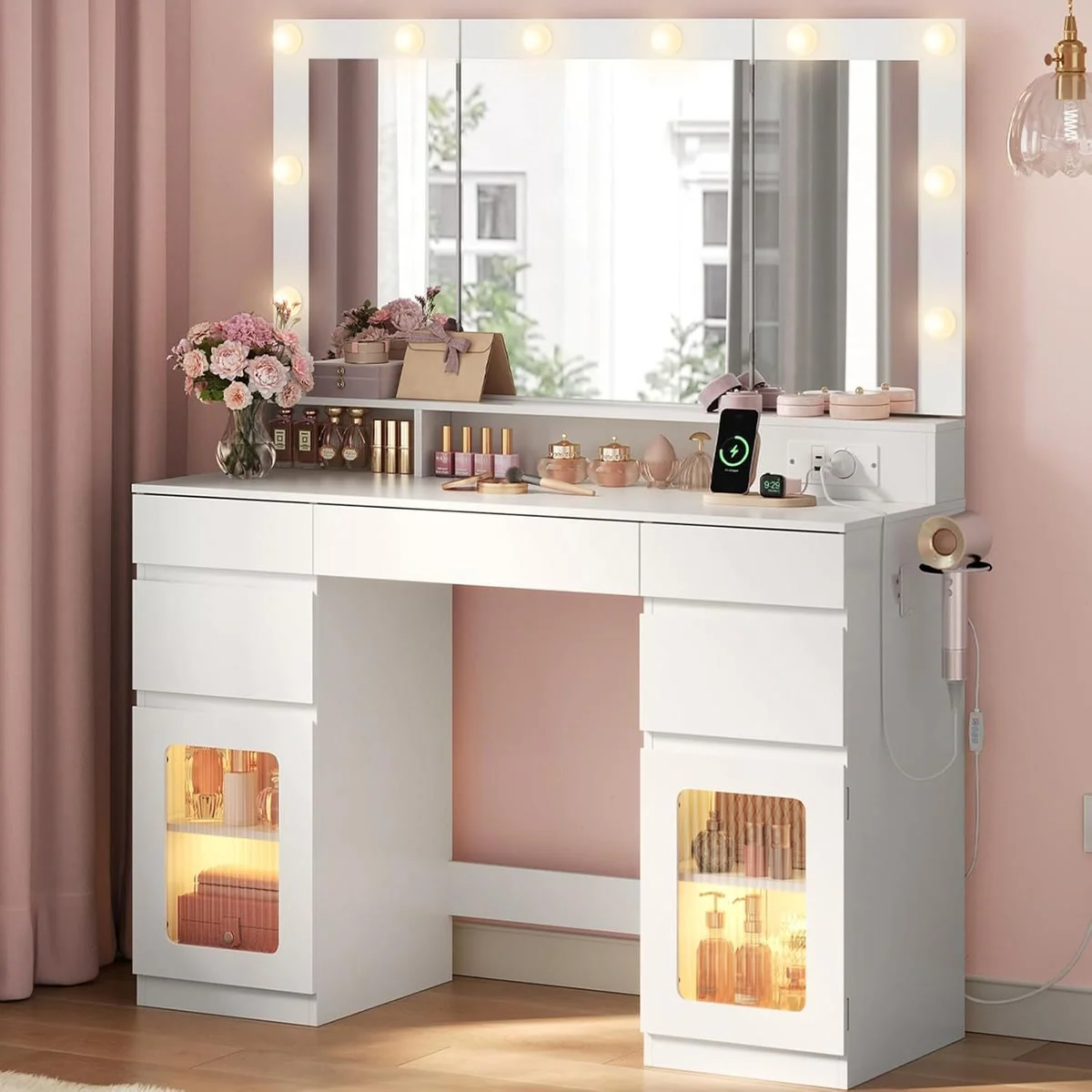 White 104 cm dressing table in a bedroom, with 10 LEDs lit around the tri-fold mirror