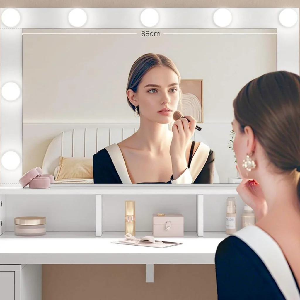 A woman doing her make-up in front of the mirror with 9 bulbs