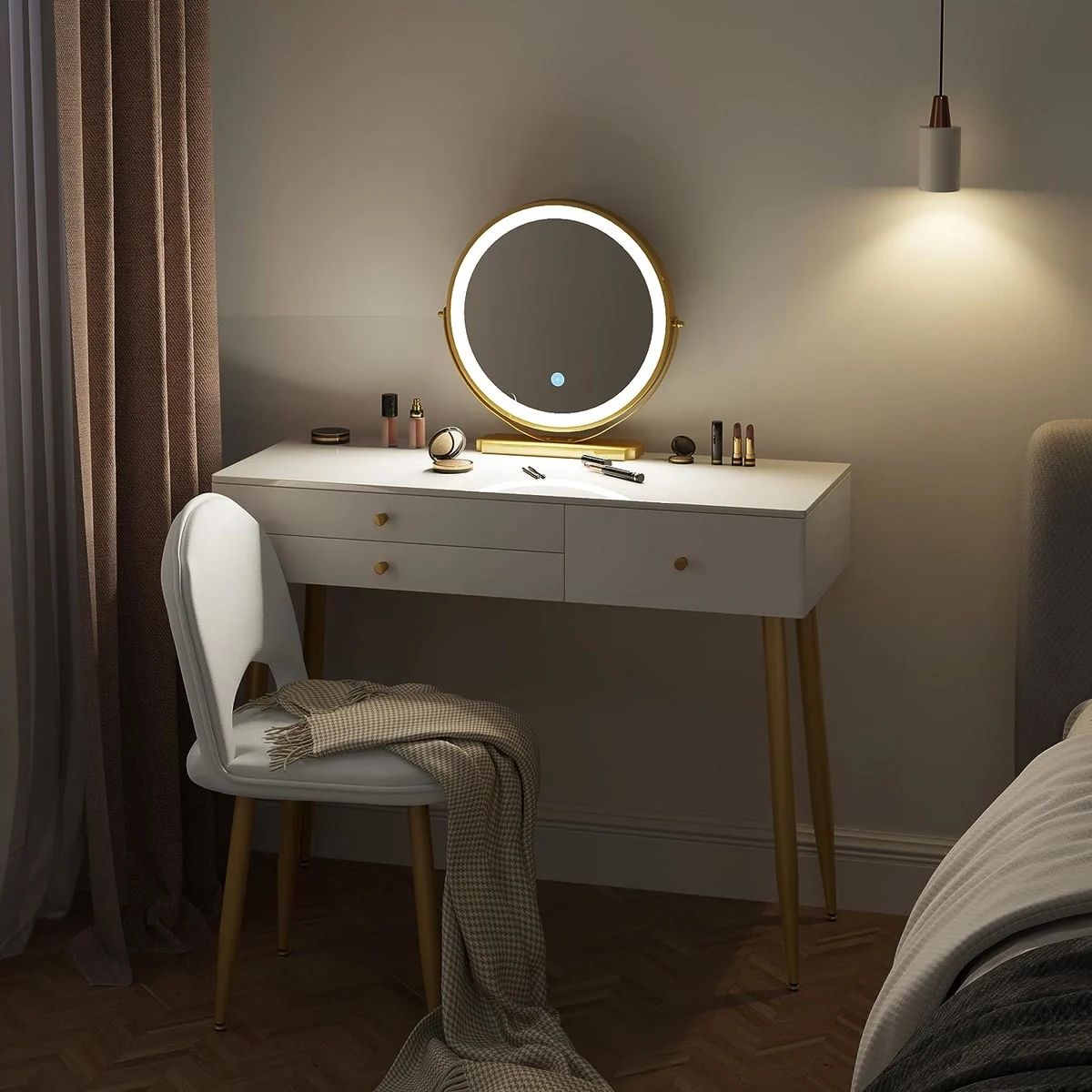 White dressing table with gold legs in the evening, round mirror lit up and velvet chair