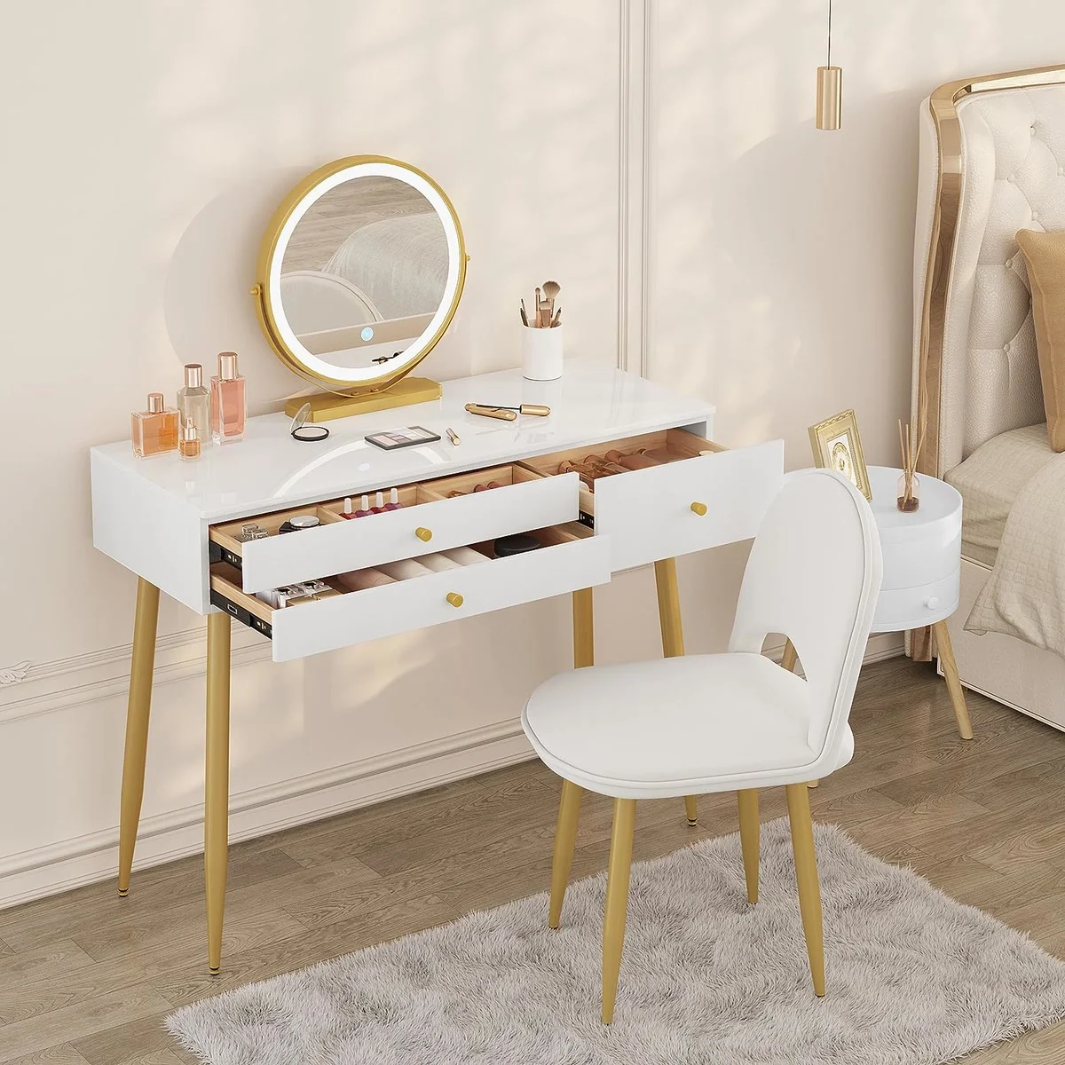 The 3 drawers open, one with 6 compartments, and the velvet chair